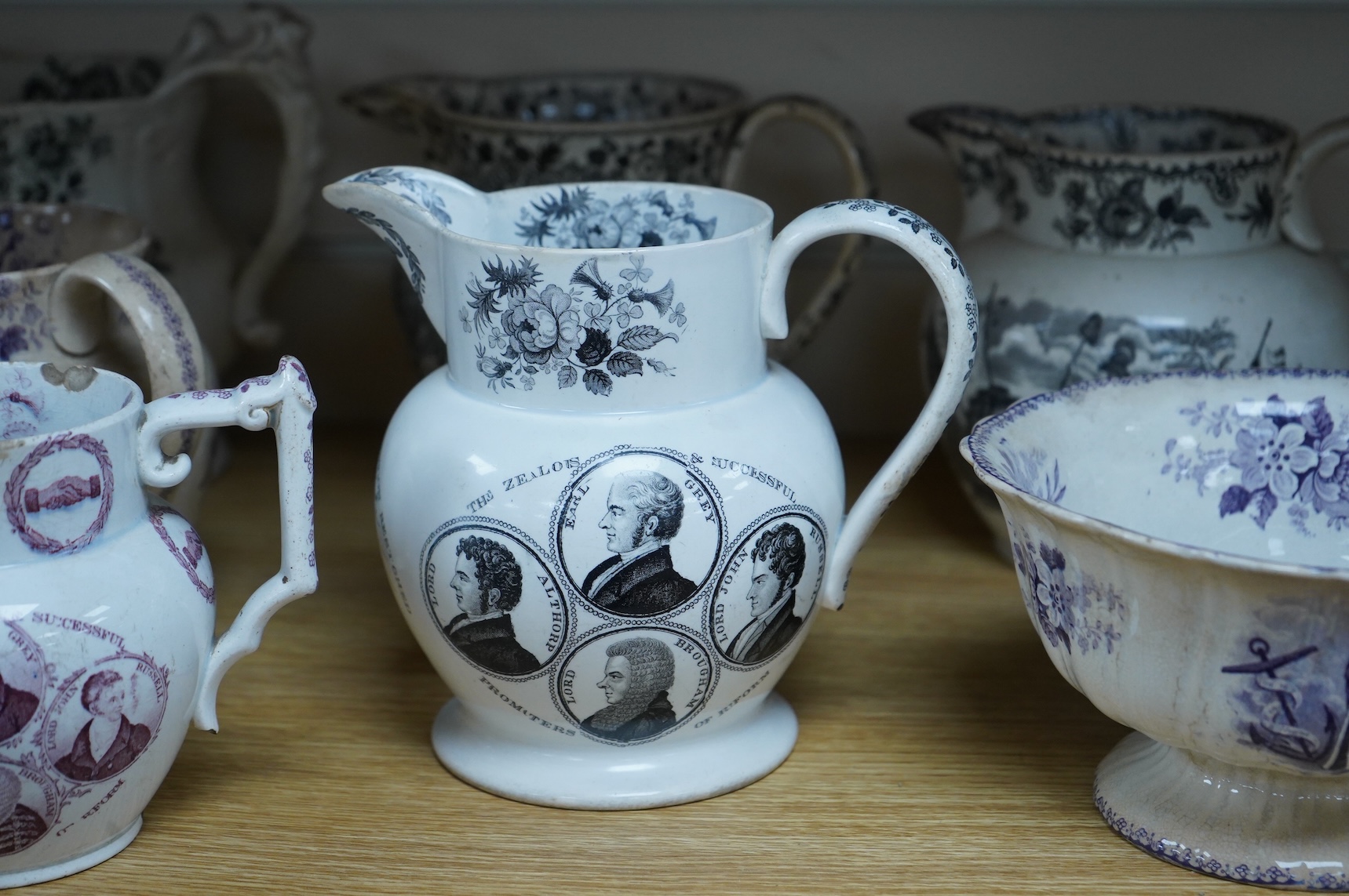Six contemporary political themed earthenware pottery jugs and a pedestal bowl commemorating the 1832 Reform Bill, with transfer printed symbolic scenes of the Houses of Parliament, details regarding the voting, portrait